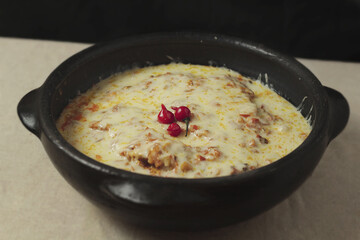 Moqueca - fish with sauce covered with cheese