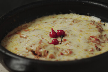 Moqueca - fish with sauce covered with cheese