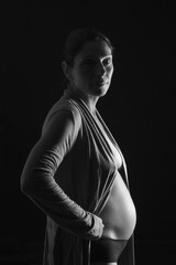 Fototapeta na wymiar portrait of a pregnant woman with shirt with black and white, six month