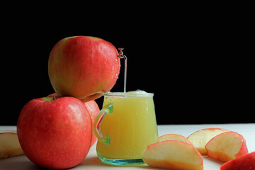 A small scale model tap extracting fresh apple juice from an apple.