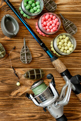 Accessories for carp fishing and fishing baits on wooden planks with copy space