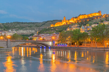 Cityscape of illuminated historic old Tbilisi with ancient Narikala fortress, Sioni Cathedral, ...