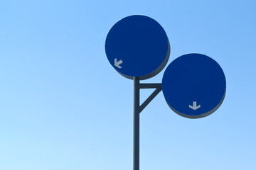 Two mandatory road signs with copy space in front of blue sky 