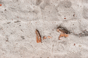 Old white wall of stone, brick and cement