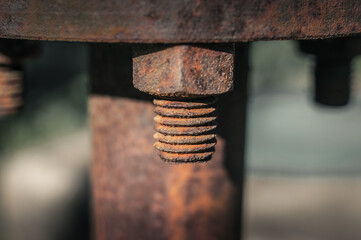 Close-up image of old rusty steel bolt with blurred background