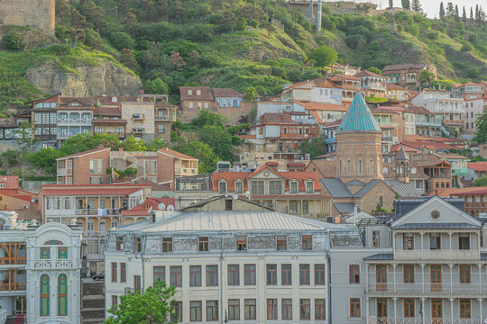 Colorful traditional houses with wooden balconies and red roofs in the Old Tbilisi in the evening. Tbilisi, Georgia
