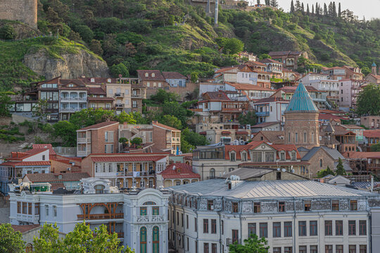 Colorful traditional houses with wooden balconies and red roofs in Old Tbilisi in the evening. Tbilisi, Georgia
