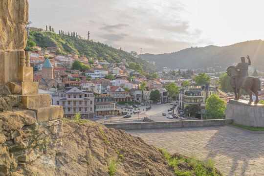 Cityscape of Old Tbilisi with King Vakhtang Statue, colorful houses and churches from the Metechi cliff in the evening