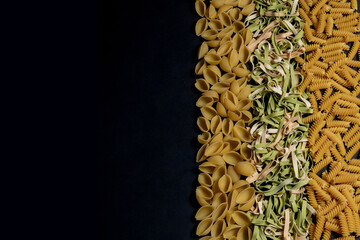 Variety of types and shapes of dry Italian pasta. Italian Macaroni raw food background or texture:pasta, spaghetti , pasta in shape of spiral.