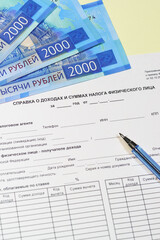 Obraz premium Tax form of the Russian individual payer for the past year. certificate of income and tax amounts of an individual, rubles and pen