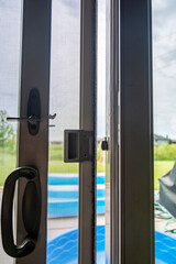 Handle, locking hardware, and jam to a sliding glass and screen door.