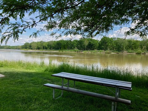 wooden bench next to the river