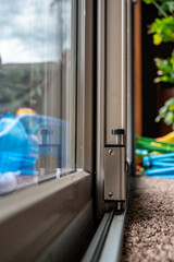 Fototapeta na wymiar Push locking mechanism for sliding glass door hardware security