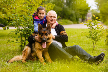 Grandfather And Granddaughter Taking Dog For Walk