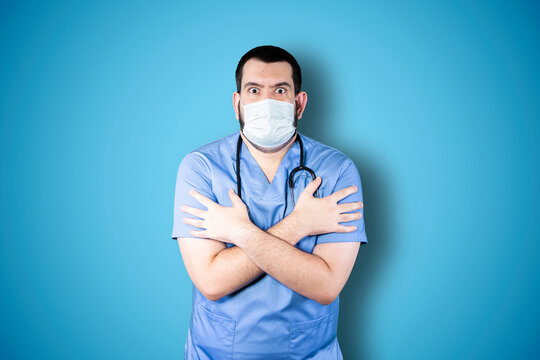 Close Up Portrait Of Young Bearded Doctor With Mask Being Frozen Waiting Friend Outside In Winter. Cold Season