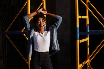 African girl in the sun in the city. Hipster