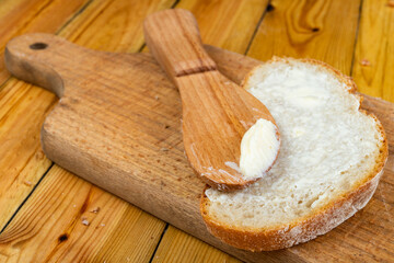 Butter spreading on fresh bread. Bread in the home kitchen.