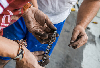 Mechanic Dirty hands fixing a bicycles chain 