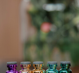 Colored bottles with rubber stoppers. The upper halves of the vials. Bottles for medicine and cosmetology