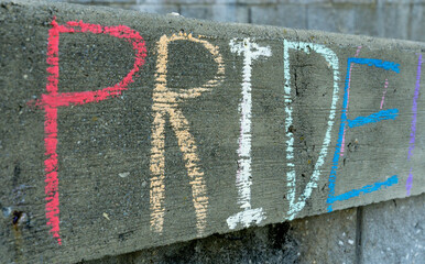 PRIDE in colorful chalk on concrete wall for LGBTQ+ June Pride Month photograph