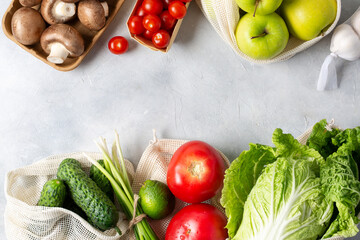 Plastic free. Healthy food. Fresh vegetables and fruits in eco-friendly reusable cotton bags. Top view. Space for text.