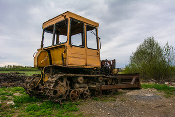 Broken tractor on tracks in the field