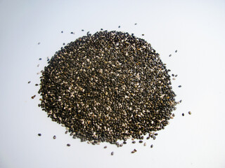 a handful of chia seeds on a white background. The view from the top.