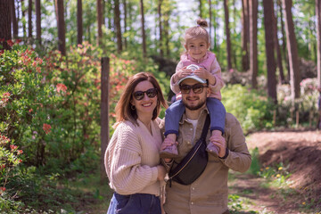 Happy Family walking in botanical garden. Rhododendron park.