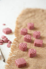 On a burlap of pink chocolate candy.

