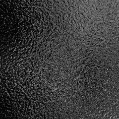 Black metallic foil paper texture background.