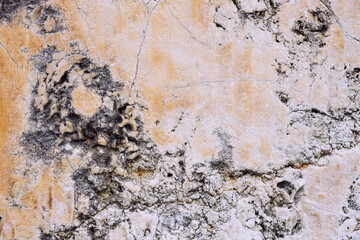 Marble stone wall, cement wall cracked and uneven, weathered wall with space for text, no person and horizontal

