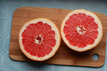 Fototapeta na wymiar red grapefruit on wooden background