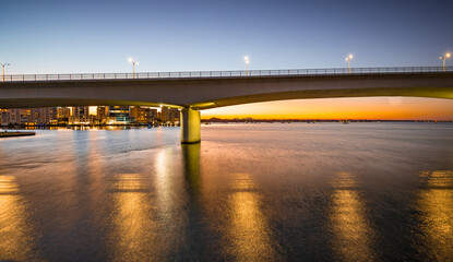 Fototapeta na wymiar Sunrises behind Sarasota's Circus bridge at dawn