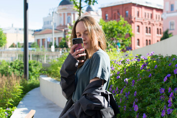 The girl takes a photo in the camera for social networks. Photographs on a smartphone.