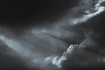 Black-and-white tinted image of dark clouds in the evening