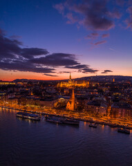 Aerial drone of lighted Matthias Church on Buda hill during Budapest sunset