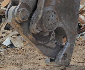 Close up metal shear in scrap yard