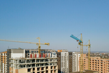 Construction and construction of high-rise buildings, the construction industry with working equipment and workers. View from above, from above. Background and texture
