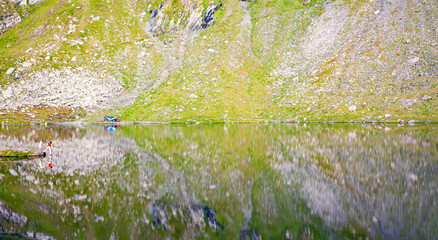 A beautiful landscape with the Balea lake. Transfagarasan Road.  The calm water of the lake.