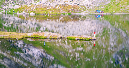 A beautiful landscape with the Balea lake. Transfagarasan Road. Island and the calm water of the lake.