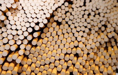 Mass of loose cigarettes showing filters