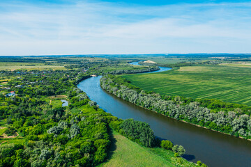 Fototapeta na wymiar Beautiful green summer nature landscape with river and meadows, aerial view drone shot.