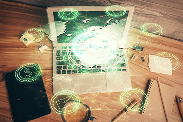 Social network hologram drawings over computer on the desktop background. Top view. Multi exposure. Concept of people connection.
