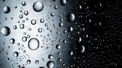 Water drops on glass window surface background. Clear transparent water droplets macro beading wallpaper