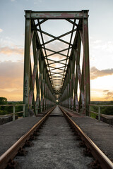 Fototapeta na wymiar abandoned railway bridge during sunset 