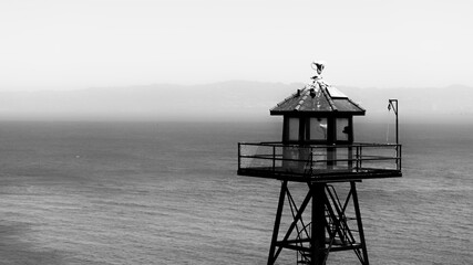 Prison watch tower on Alcatraz Island black and white background and copy space