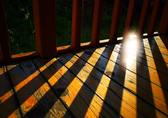 Wooden gallery with dramatic sunset shadows