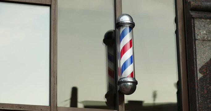 Men's beauty salon. Barbershop. Symbol of the barber, pole.