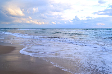 Tropical beach with colorful sunset, cloudy sky. A copy of the space.