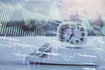Multi exposure of financial graph drawings and desk with open notebook background. Concept of forex